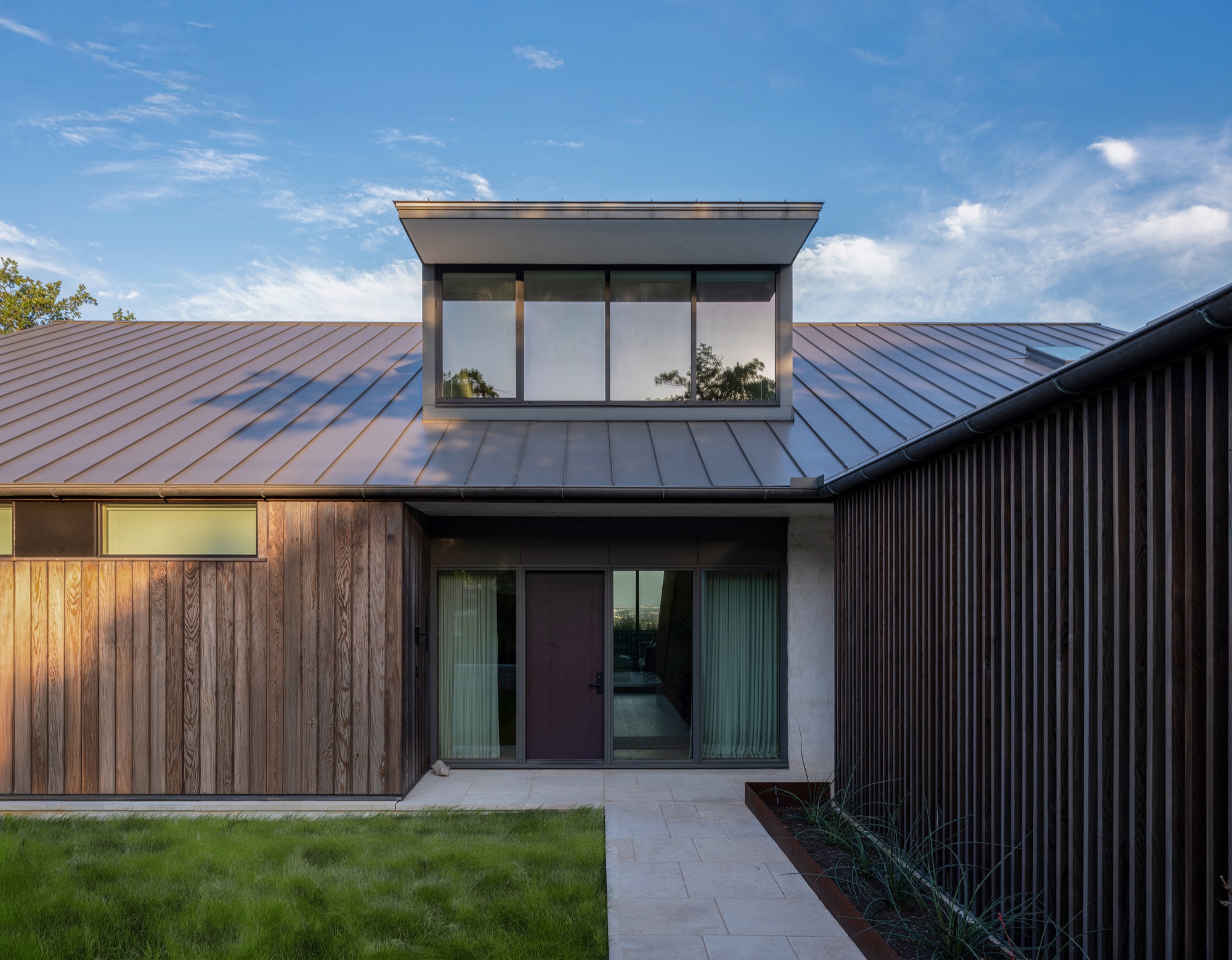 Hillside House entry dormer with slat screen in West Lake Hills, Texas
